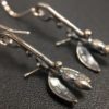 ujo_rocks_buzz_lightbutt_ville_valopylly_firefly_earrings_sterling_silver_glow_in_the_dark_frosted_oxidised_daytime_back