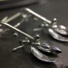 ujo_rocks_buzz_lightbutt_ville_valopylly_firefly_earrings_sterling_silver_glow_in_the_dark_polished_daytime_back