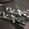 ujo_rocks_buzz_lightbutt_ville_valopylly_firefly_earrings_sterling_silver_glow_in_the_dark_polished_daytime_side