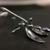 ujo_rocks_buzz_lightbutt_ville_valopylly_firefly_pendant_sterling_silver_glow_in_the_dark_polished_daytime_back