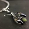 ujo_rocks_buzz_lightbutt_ville_valopylly_firefly_pendant_sterling_silver_glow_in_the_dark_polished_daytime_front