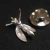 ujo_rocks_buzz_lightbutt_ville_valopylly_firefly_pin_sterling_silver_glow_in_the_dark_frosted_daytime_back