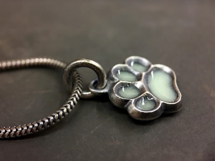 ujo_rocks_paw_pendant_sterling_silver_aqua_glow_in_the_dark_frosted_oxidised_daytime_side