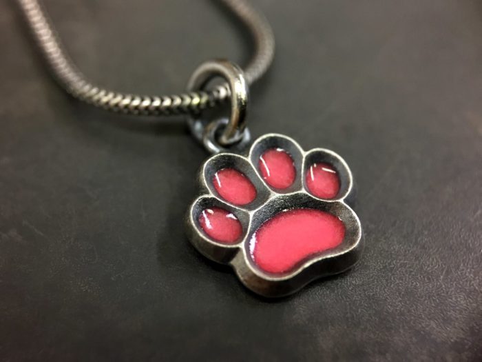 ujo_rocks_paw_pendant_sterling_silver_cotton_candy_glow_in_the_dark_frosted_oxidised_daytime_front