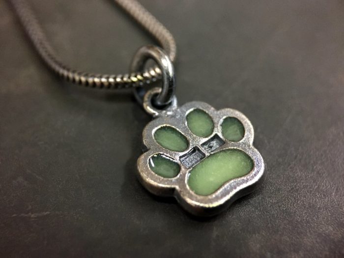 ujo_rocks_paw_pendant_sterling_silver_green_glow_in_the_dark_frosted_oxidised_daytime_back