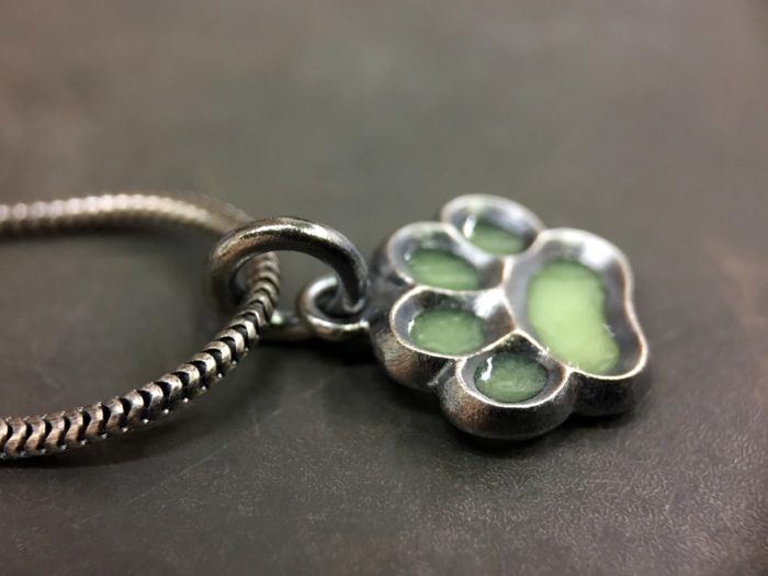 ujo_rocks_paw_pendant_sterling_silver_green_glow_in_the_dark_frosted_oxidised_daytime_side