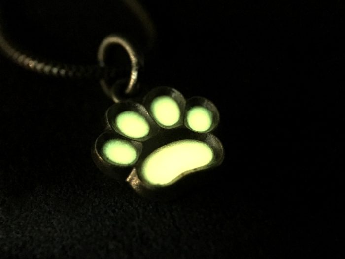 ujo_rocks_paw_pendant_sterling_silver_orange_glow_in_the_dark_frosted_oxidised_nighttime_front