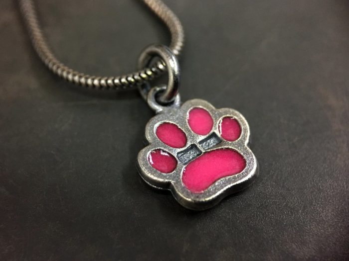 ujo_rocks_paw_pendant_sterling_silver_pink_glow_in_the_dark_frosted_oxidised_daytime_back