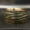 ujo_rocks_tree_bark_ring_bronze_green_glow_in_the_dark_polished_daytime_front