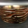ujo_rocks_tree_bark_ring_bronze_orange_glow_in_the_dark_polished_daytime_front